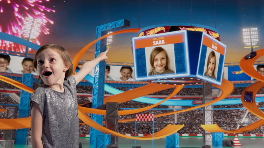 Little Girl named Sara is excited to see her name and picture on the screen in the Hot Wheels Champion Experience Stadium.